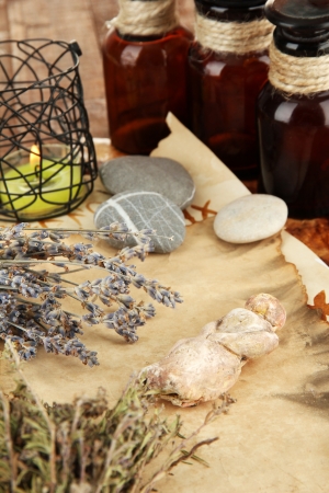 Composition with old papers, herbs, stones and bottles with symbols on wooden backgroundの写真素材