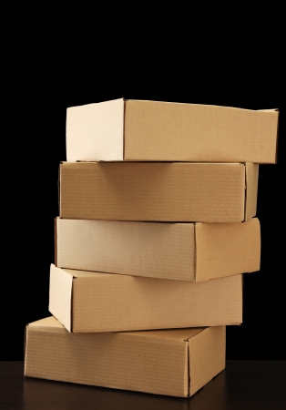 Parcels boxes on wooden table, on black backgroundの写真素材