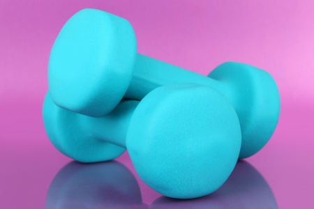 Dumbbells on purple backgroundの写真素材