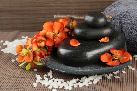 Spa stones and flowers on bamboo backgroundの写真素材