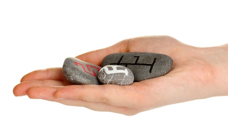 Fortune telling  with symbols on stone in hand isolated on white