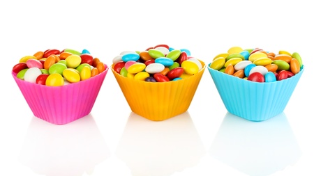 Colorful candies in cupcake cases isolated on whiteの写真素材