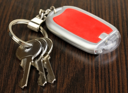 House keys and keychain on wooden backgroundの写真素材