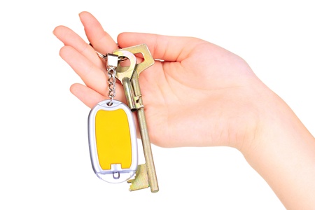 Keychain with house keys in hand  isolated on white