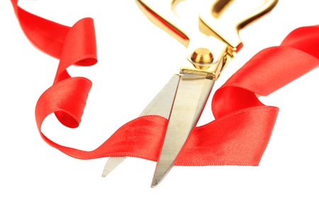 Satin ribbon curled around scissors isolated on whiteの写真素材