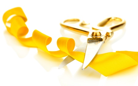Satin ribbon curled around scissors isolated on whiteの写真素材