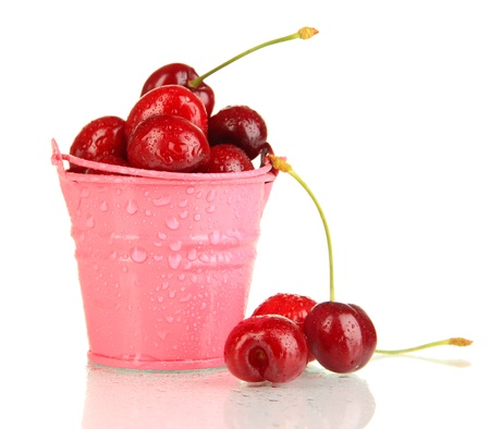 Ripe red cherry berries in pail isolated on whiteの写真素材