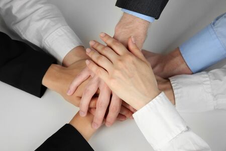 Group of young people's hands isolated on white