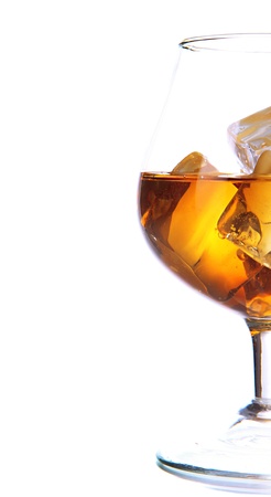 Brandy glass with ice isolated on whiteの写真素材