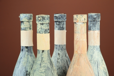 Old bottles of wine, on dark brown backgroundの写真素材