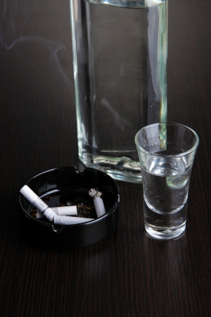 Vodka bottle and cup on table close-upの写真素材