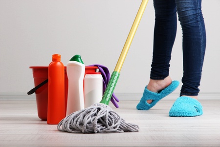 Woman cleaning floor in room close-upの写真素材