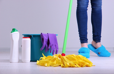 Woman Cleaning floor in room close-upの写真素材