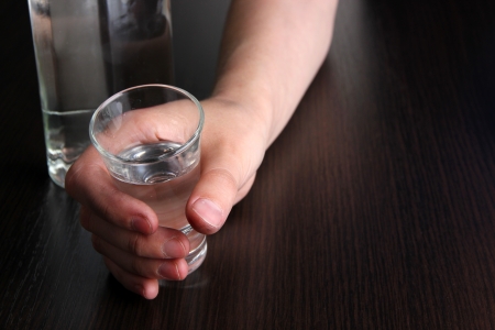 hand hold an alcohol vodka drink glass close-upの写真素材