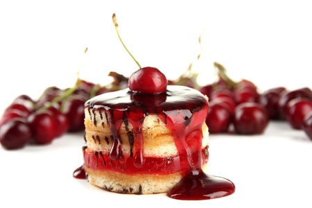 Tasty biscuit cake with jam and berries isolated on whiteの写真素材