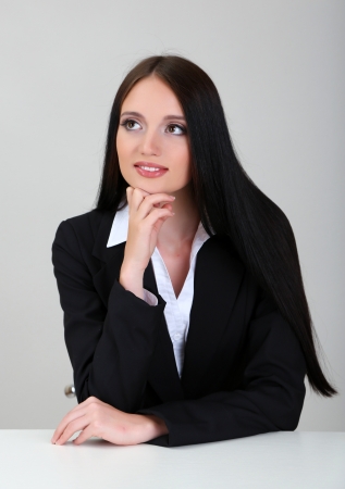 Young business woman, on gray backgroundの写真素材