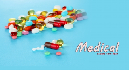 Assortment of pills, tablets and capsules on blue backgroundの写真素材