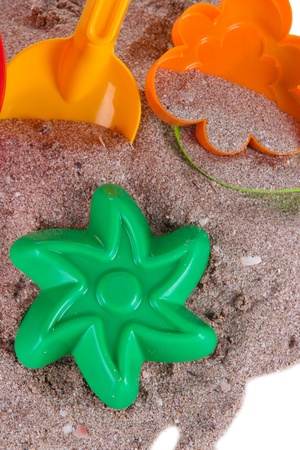 Children's toys on sand close-upの写真素材