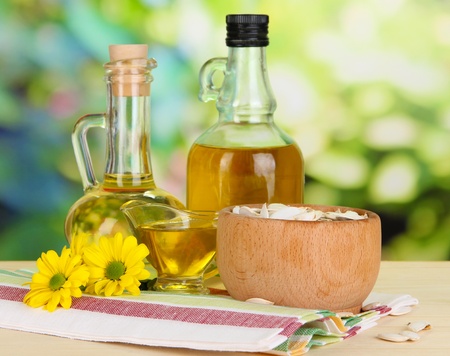 Useful pumpkin seed oil on wooden table on natural backgroundの写真素材