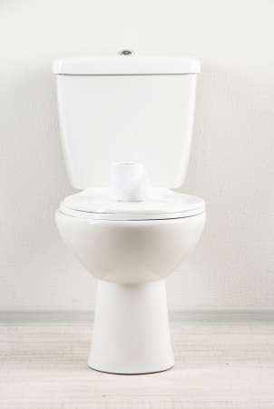 White toilet bowl with toilet paper in a bathroomの写真素材