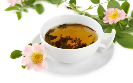 Cup of herbal tea with hip rose flowers, isolated on whiteの写真素材