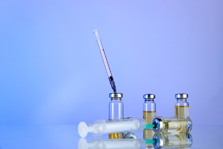 Medical bottles and syringes on light gray backgroundの写真素材