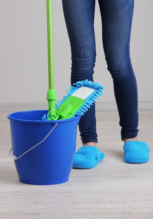 Woman Cleaning floor in room close-upの写真素材