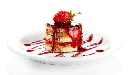 Tasty biscuit cake with jam and berries on plate, isolated on whiteの写真素材