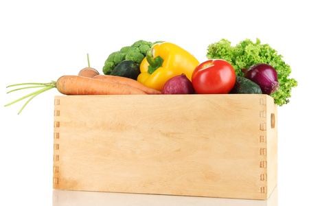 Fresh vegetables in wooden boxes on white backgroundの写真素材