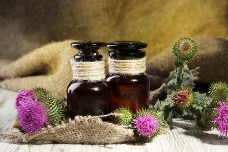 Medicine bottles with thistle flowersの写真素材