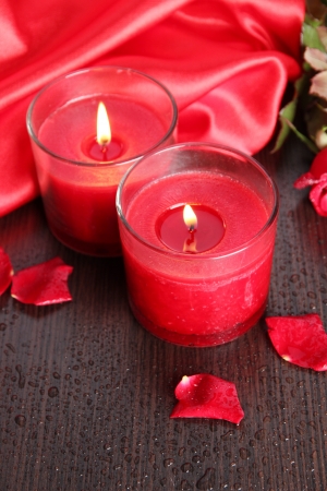 Beautiful romantic red candle with flowers, close upの写真素材