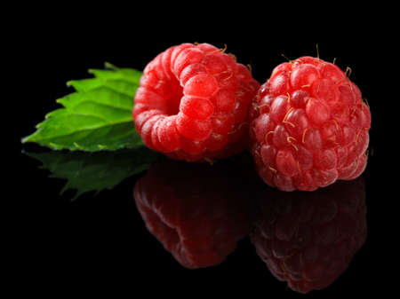 Ripe sweet raspberries on dark backgroundの写真素材