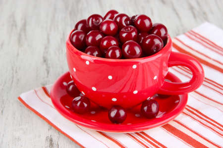 Sweet cherry in cup on table close-upの写真素材