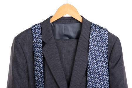 Suit and tie on hanger on white background