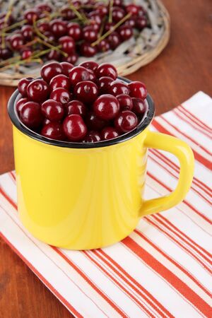 Sweet cherry in cup on table close-upの写真素材