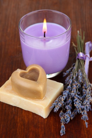 Lavender candle with fresh lavender, soap on wooden backgroundの写真素材