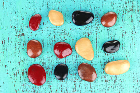 Colorful pebbles, on color wooden background