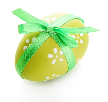 Bright easter egg with bow, isolated on whiteの写真素材