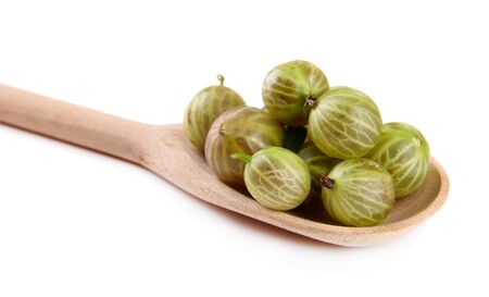 Gooseberry in wooden spoon isolated on whiteの写真素材