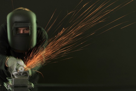 Portrait of workman in black mask, isolated on blackの写真素材