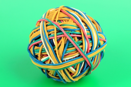 Colorful rubber bands on green backgroundの写真素材
