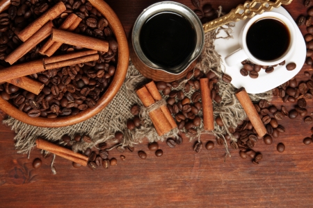 Coffee beans, metal turk and coffee mill on wooden background with copy spaceの写真素材