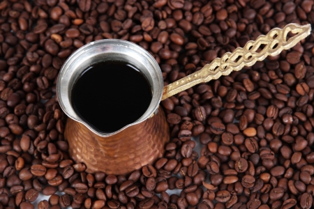 Coffee pot on coffee beans backgroundの写真素材
