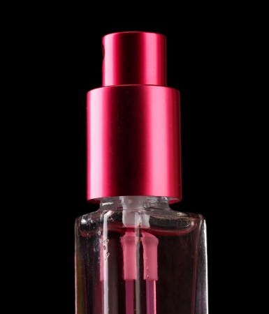 women's perfume in bottle and spraying, on black backgroundの写真素材