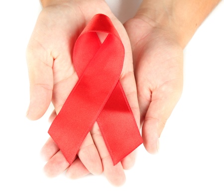 AIDS ribbon in hands isolated on white