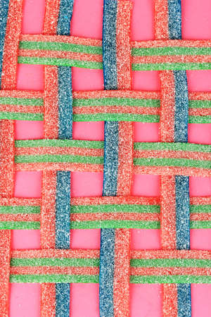 Sweet jelly candies on pink background