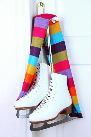Figure skates hanging on a door knob with scarfの写真素材