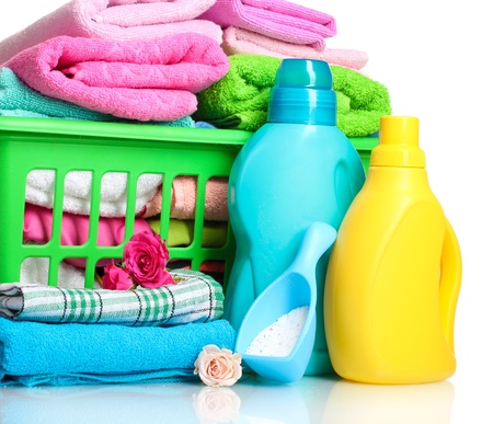 Detergents and towels in green plastic basket isolated on whiteの写真素材