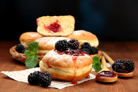 Tasty donuts with berries on wooden tableの写真素材