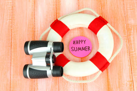 Lifebuoy on color wooden backgroundの写真素材